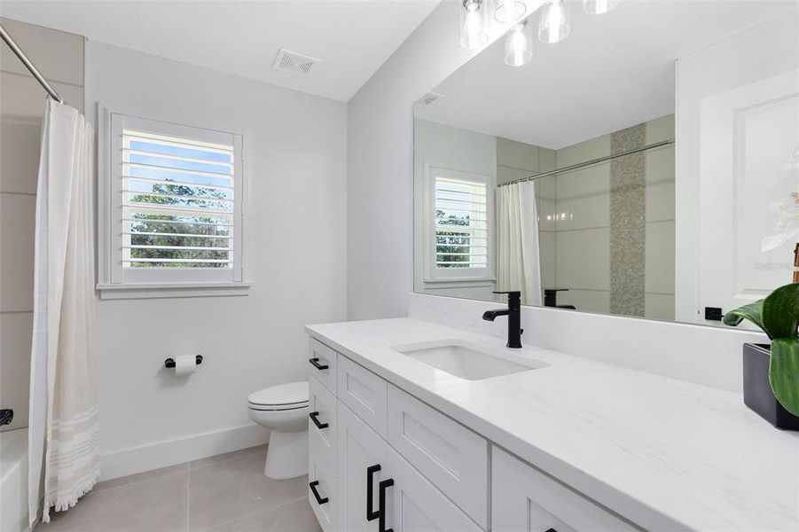 Your secondary bath has a tub/shower combo and a quartz topped vanity.