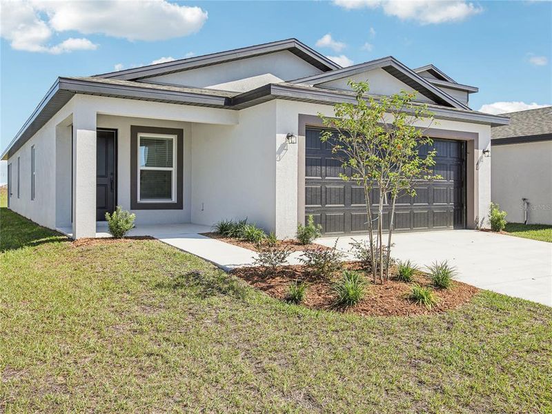 Front exterior of a new home in Fulton Meadows, Lakeland, FL, highlighting curb appeal (Image 2). Front exterior of a new home in Fulton Meadows, Lakeland, FL, highlighting curb appeal (Image 2).