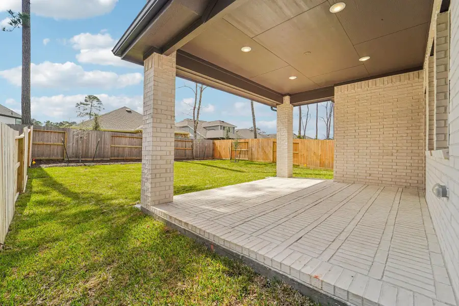 Exterior details and patio area of a home in The Woodlands Hills, Willis (Image 4).