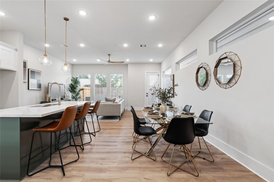 Designed for both everyday living and entertaining, the main floor balances openness with intention. A true dining space anchors the layout, while expansive windows and high ceilings create a light-filled, connected environment.