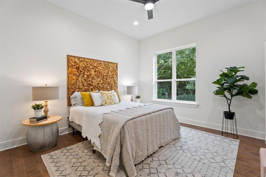 Bedroom featuring dark wood-type flooring and ceiling fan Bedroom featuring dark wood-type flooring and ceiling fan
