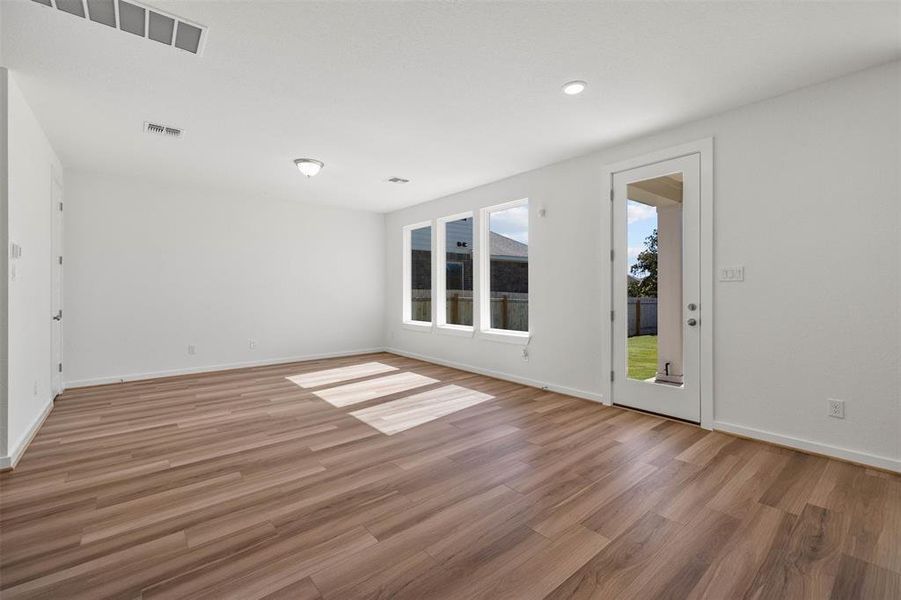 Unfurnished room with light wood-type flooring and baseboards Unfurnished room with light wood-type flooring and baseboards
