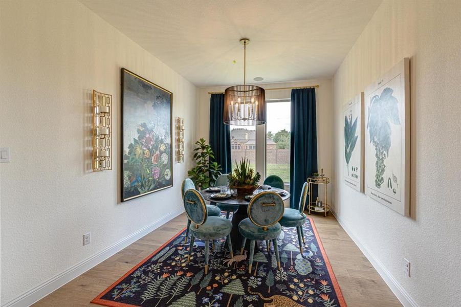 Dining area with a notable chandelier and light hardwood / wood-style flooring