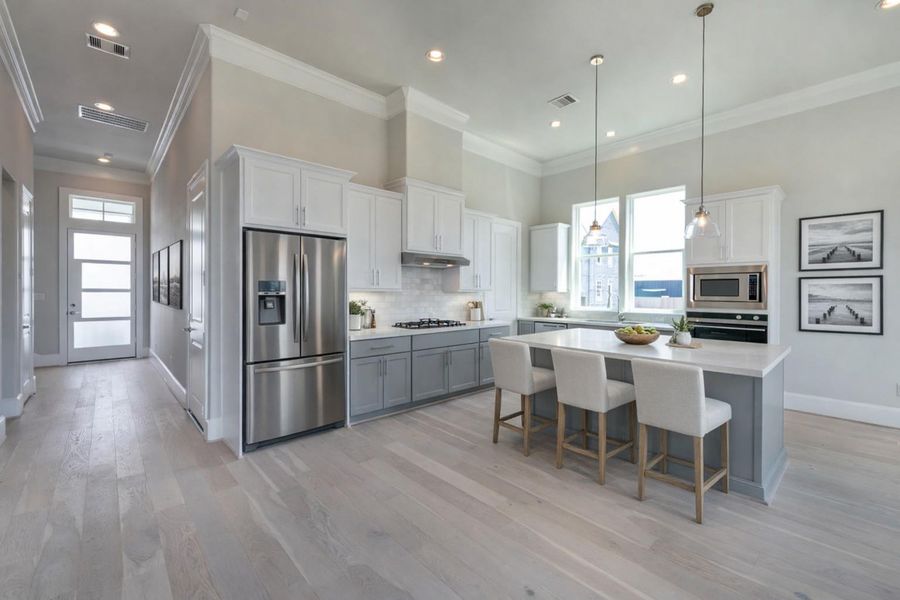 Bright first-floor living and dining bathed in natural light.   Virtual staging added.