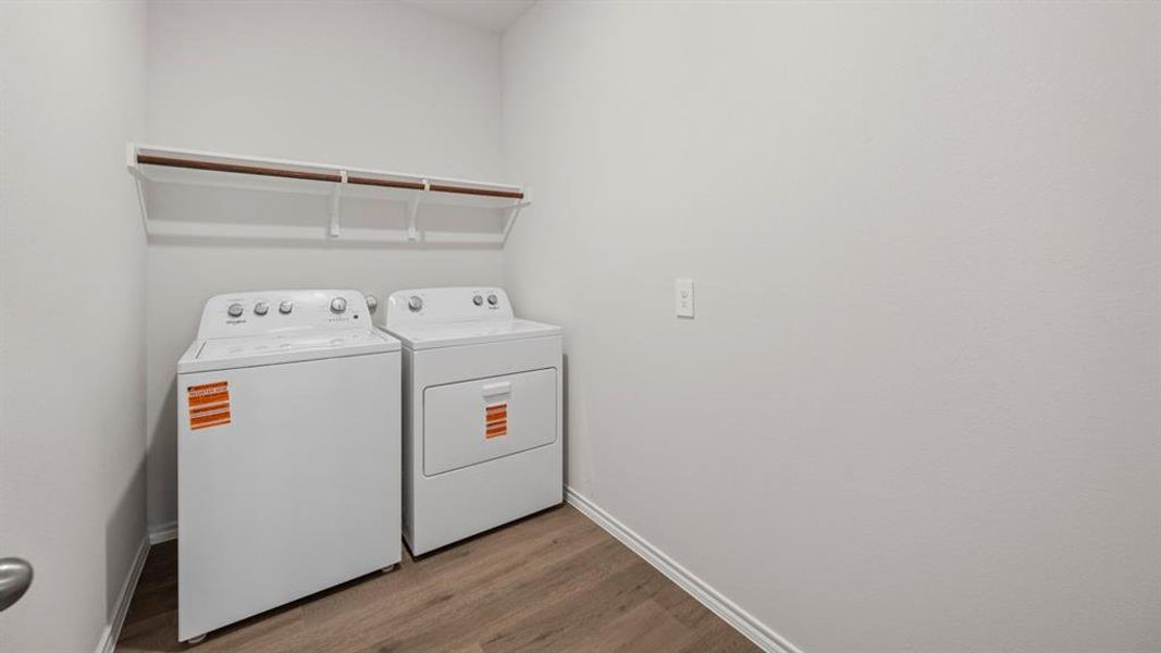 Laundry room featuring dark wood-style floors and washing machine and clothes dryer