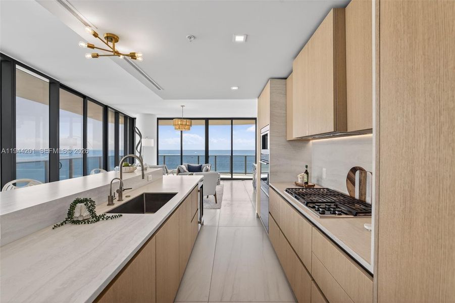 Chef-ready galley kitchen with Sub-Zero and Wolf appliances w/ wine cooler, plus integrated espresso/cappuccino system. Italian cabinetry and stone counters. Gas Cooktop