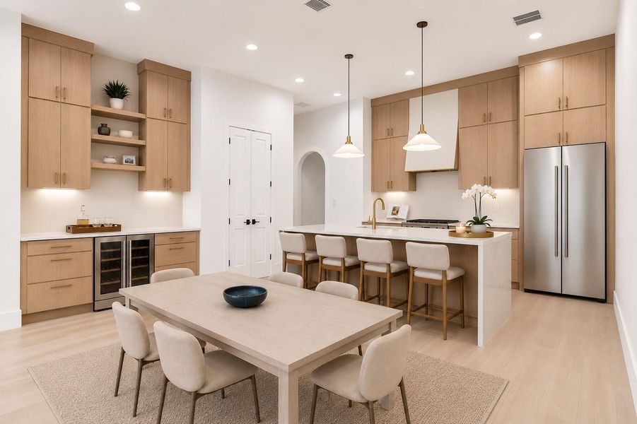 Chef-inspired kitchen featuring white oak cabinetry, a quartz waterfall island and an entertainment bar.