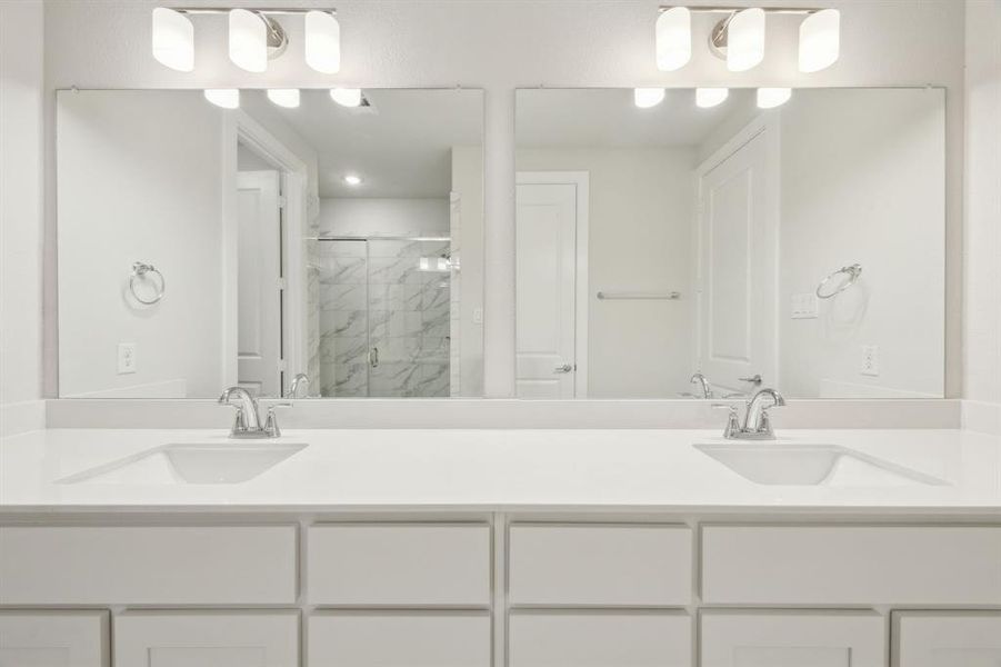 Primary Bathroom featuring dual vanity and walk in shower