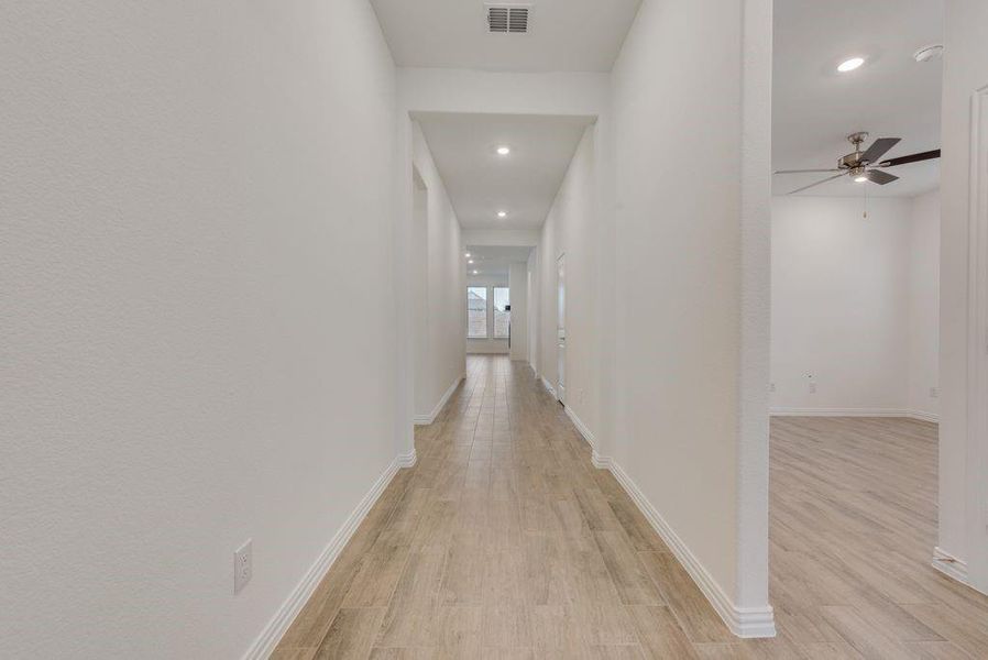 Hall with light hardwood / wood-style flooring