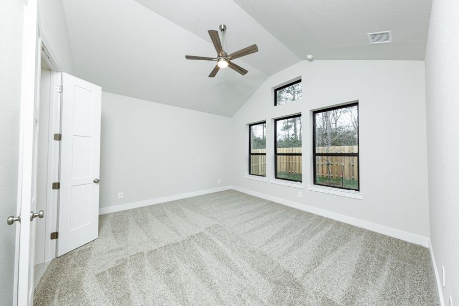 Relax and unwind after a long day in this impressive primary suite! This generously sized room offers plush carpeting, neutral-toned paint, high ceilings with a ceiling fan, and large windows for added comfort and tranquility. Relax and unwind after a long day in this impressive primary suite! This generously sized room offers plush carpeting, neutral-toned paint, high ceilings with a ceiling fan, and large windows for added comfort and tranquility.