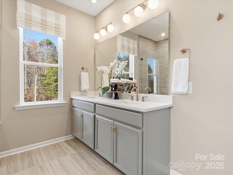 En Suite Primary Bath with Dual Vanity. *Model Photos | Actual Finishes, Structural Selections, and Orientation May Vary.