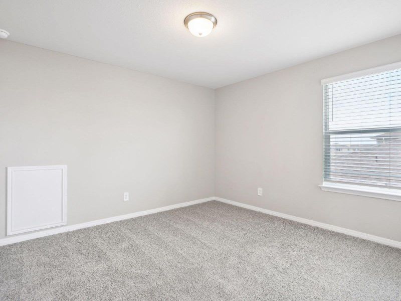Empty room with carpet flooring and baseboards Empty room with carpet flooring and baseboards