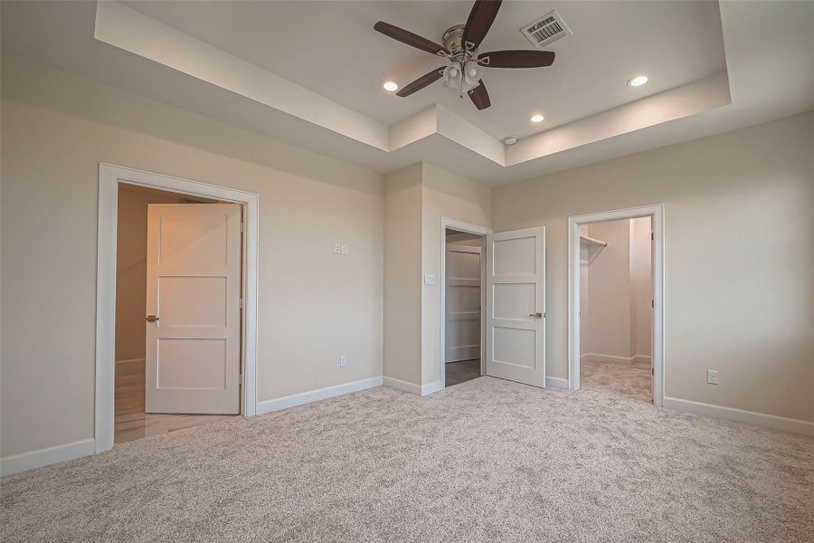 Unit 2: Primary bedroom with spa-inspired ensuite and separate walk in closet with storage shelving.