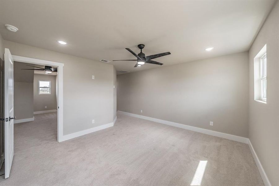 Empty room featuring light colored carpet, a ceiling fan, and recessed lighting Empty room featuring light colored carpet, a ceiling fan, and recessed lighting