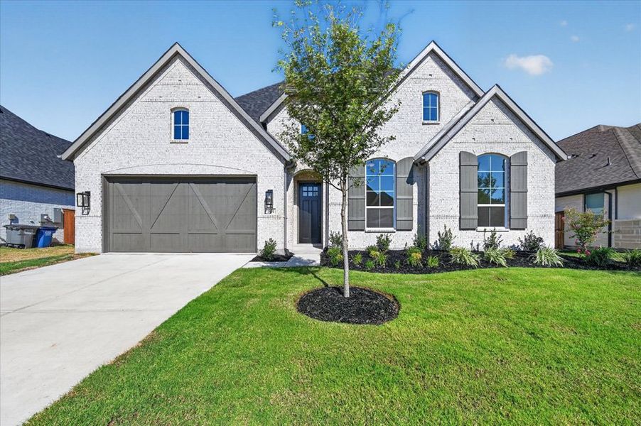 Front exterior of a new home in Sonoma Verde, McLendon-Chisholm, TX, highlighting curb appeal (Image 1). Front exterior of a new home in Sonoma Verde, McLendon-Chisholm, TX, highlighting curb appeal (Image 1).