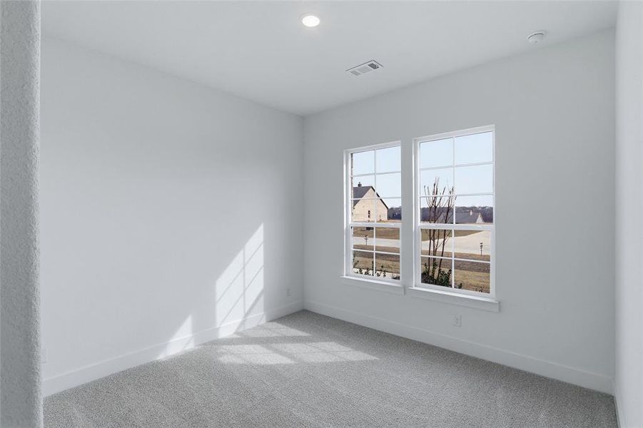Spare room with light carpet and recessed lighting