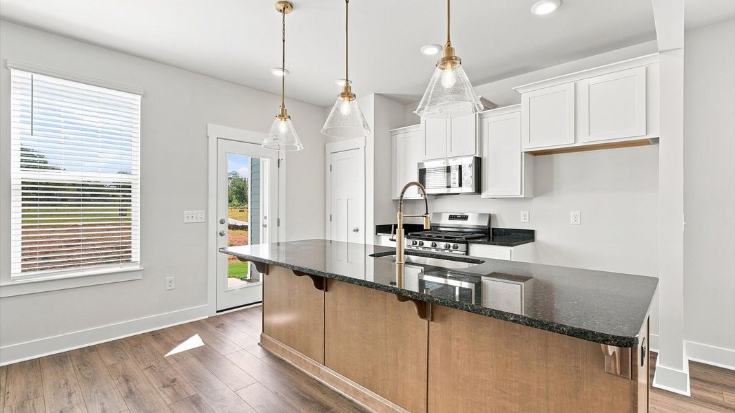 Superior craftsmanship shines in this modern kitchen with a space-saving island and open flow at Saluda Crossing Superior craftsmanship shines in this modern kitchen with a space-saving island and open flow at Saluda Crossing