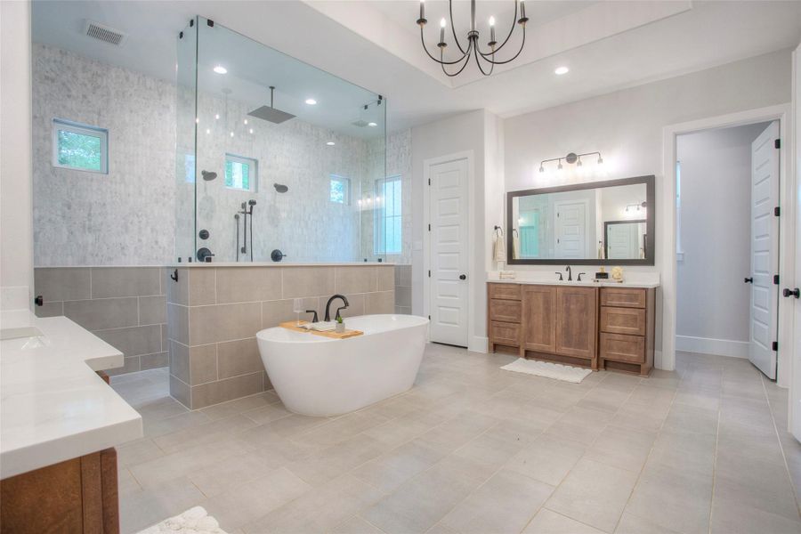 The owner's bath screams luxury all the way around.  It has it all. A luxurious freestanding tub, double sinks, a A large shower accessible from either side and two walk in closets.