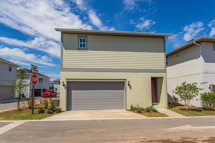 Front exterior of a new home in Laureate Park, Orlando, FL, highlighting curb appeal (Image 1). Front exterior of a new home in Laureate Park, Orlando, FL, highlighting curb appeal (Image 1).