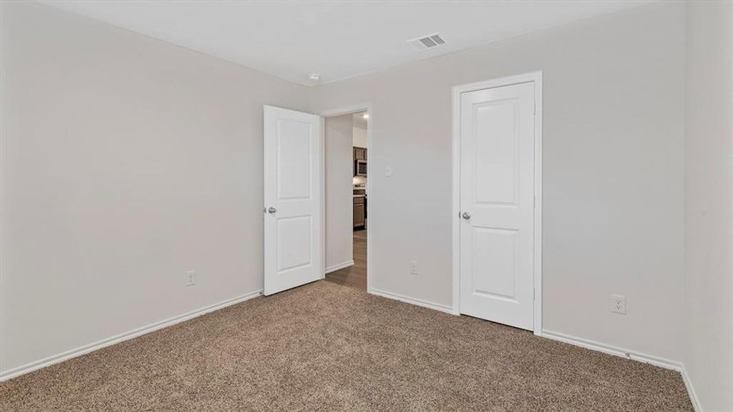 Unfurnished bedroom featuring carpet floors and baseboards