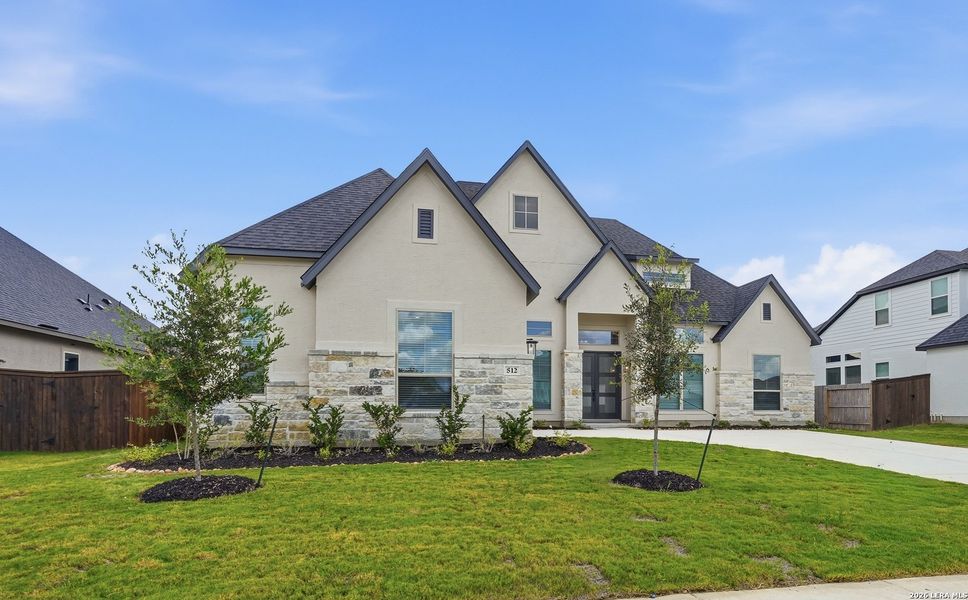 Front exterior of a new home in Mesa Western, Cibolo, TX, highlighting curb appeal (Image 2). Front exterior of a new home in Mesa Western, Cibolo, TX, highlighting curb appeal (Image 2).