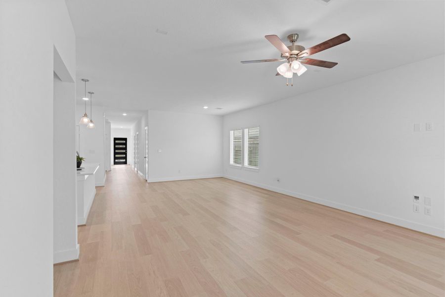 Another inviting view of the family room highlighting the open flow to the kitchen and dining area. The natural light fills every corner, making this space feel cheerful and welcoming throughout the day. **Image Representative of Plan Only and May Vary as Built**.