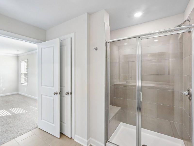 The primary bathroom features an oversized, spa-like walk-in shower.