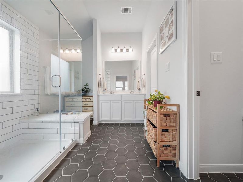 Now for this fantastic en suite!  Look at the size of that shower with a shower seat as well.  Two sinks and more storage area to the left of the sinks.... but look at this gorgeous hexagon tile and how it beautifully pops with the elongated subway tiles in the shower.