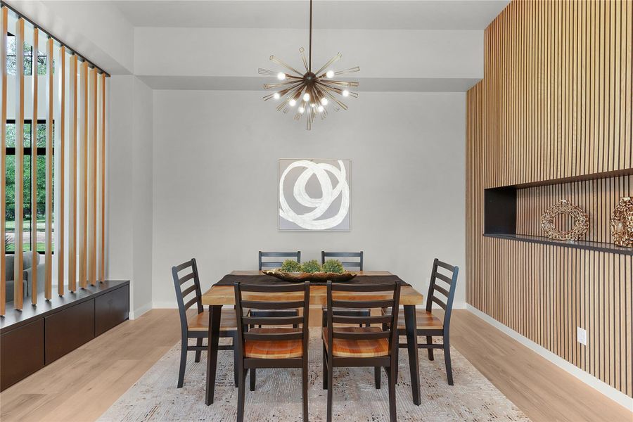 Dining room featuring a chandelier, wood finished floors Dining room featuring a chandelier, wood finished floors