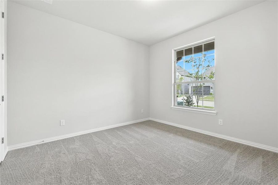Carpeted empty room featuring baseboards Carpeted empty room featuring baseboards