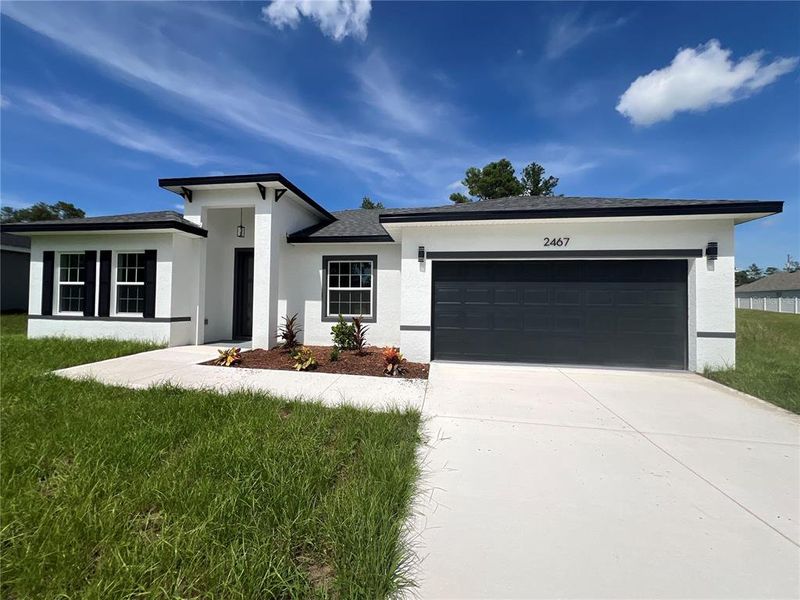 Front exterior of a new home in , Ocala, FL, highlighting curb appeal (Image 1).