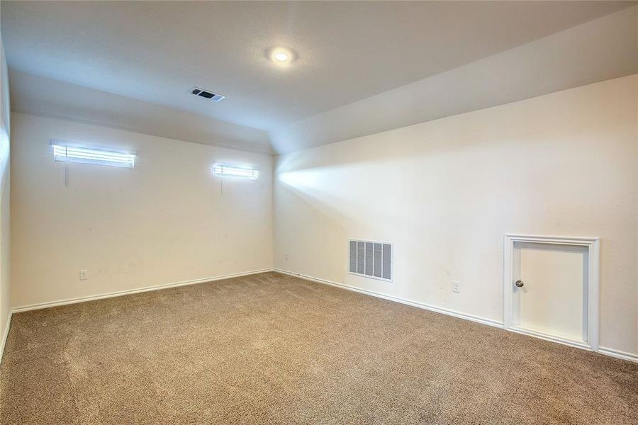 Carpeted spare room with baseboards