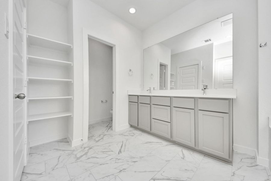Elevate your daily routine at the elegant vanity, now equipped with double sinks, light countertops, modern hardware, and beautiful recessed lights. Sample photo of completed home with similar floor plan. Actual colors and selections may vary. Elevate your daily routine at the elegant vanity, now equipped with double sinks, light countertops, modern hardware, and beautiful recessed lights. Sample photo of completed home with similar floor plan. Actual colors and selections may vary.