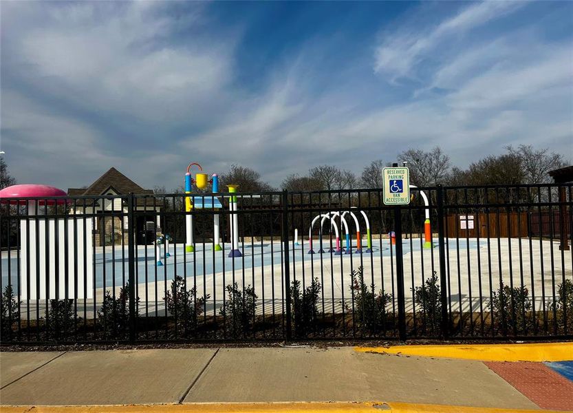 Community pool featuring a water play area