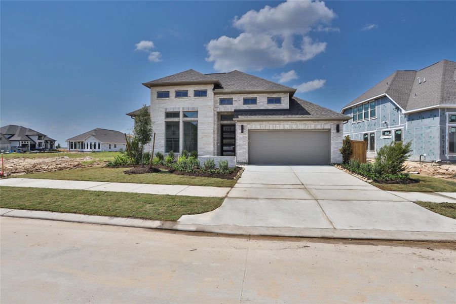 Front exterior of a new home in Bridgeland 55', Cypress, TX, highlighting curb appeal (Image 1). Front exterior of a new home in Bridgeland 55', Cypress, TX, highlighting curb appeal (Image 1).