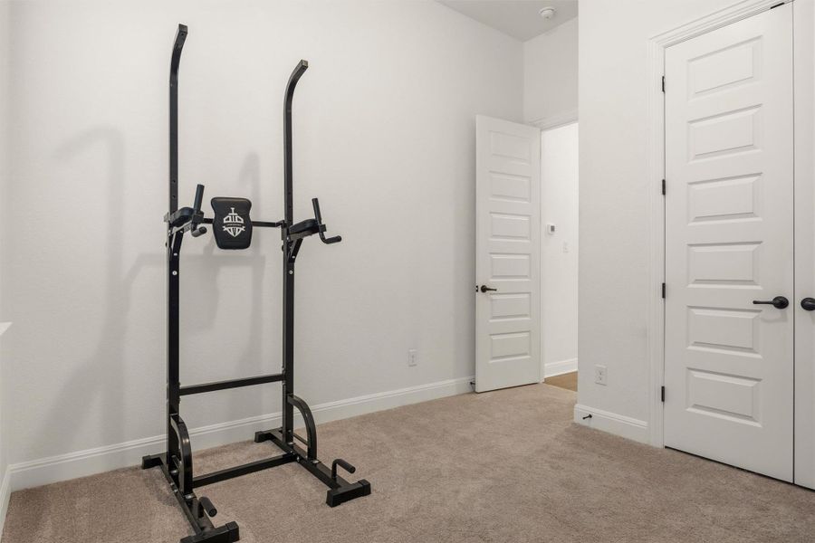 Workout area featuring light colored carpet