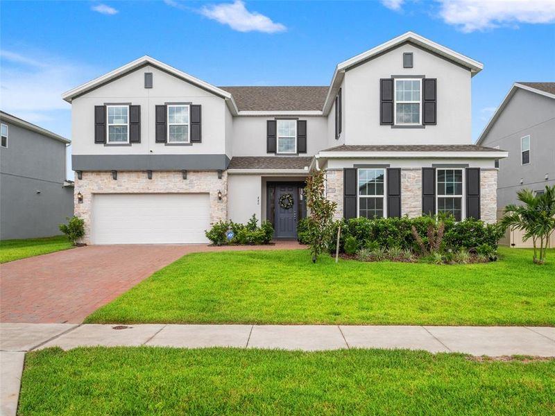 Front exterior of a new home in , Minneola, FL, highlighting curb appeal (Image 2). Front exterior of a new home in , Minneola, FL, highlighting curb appeal (Image 2).