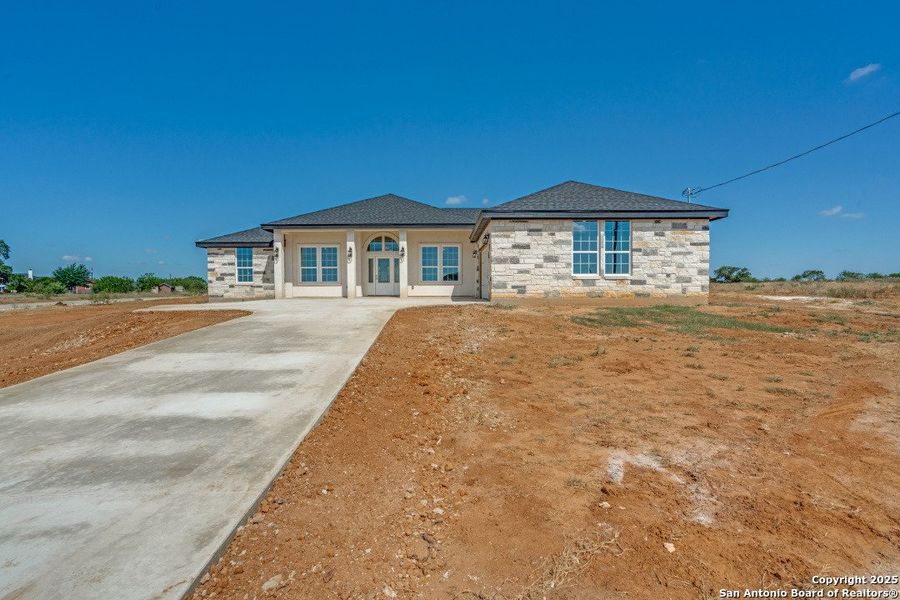 Front exterior of a new home in , Floresville, TX, highlighting curb appeal (Image 25).