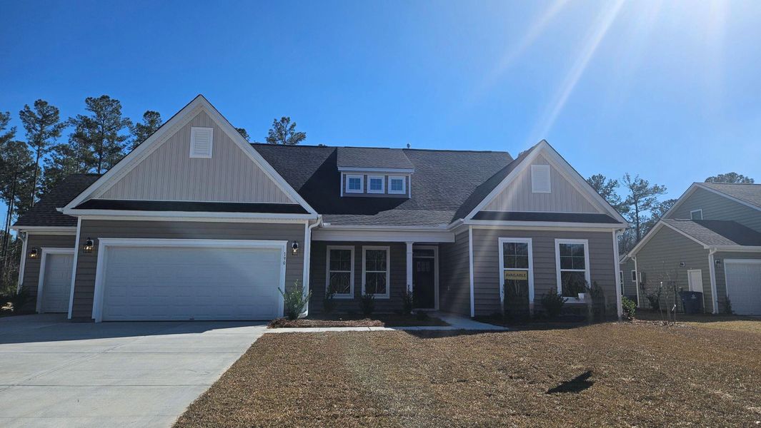 Front exterior of a new home in The Enclave at French Quarter Creek, Huger, SC, highlighting curb appeal (Image 1).