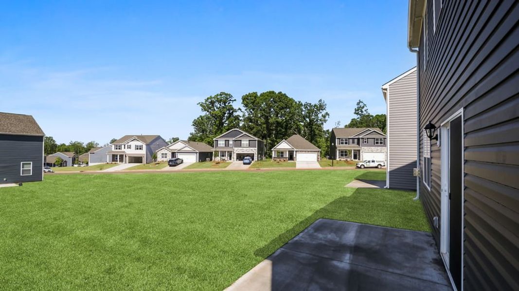 Exterior details and patio area of a home in Durbin Meadows Traditions, Fountain Inn (Image 22).