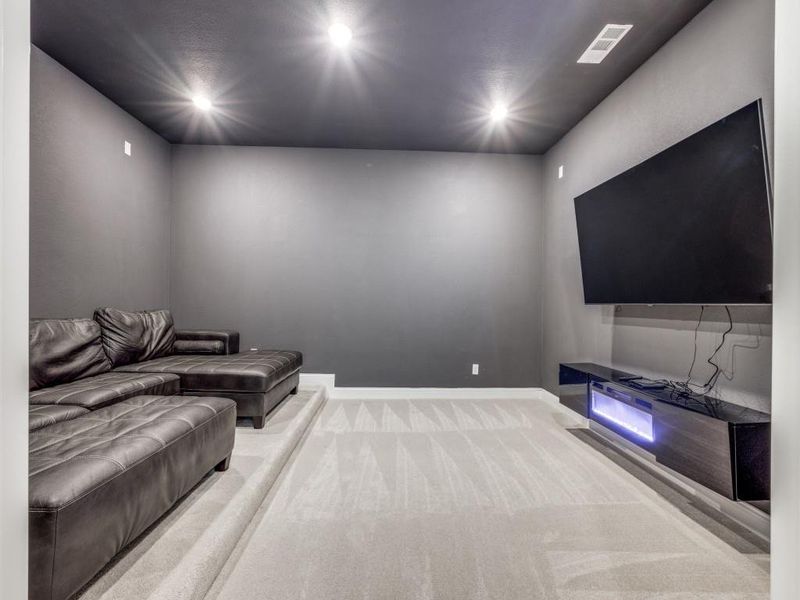 Carpeted living room with recessed lighting, baseboards, and visible vents Carpeted living room with recessed lighting, baseboards, and visible vents