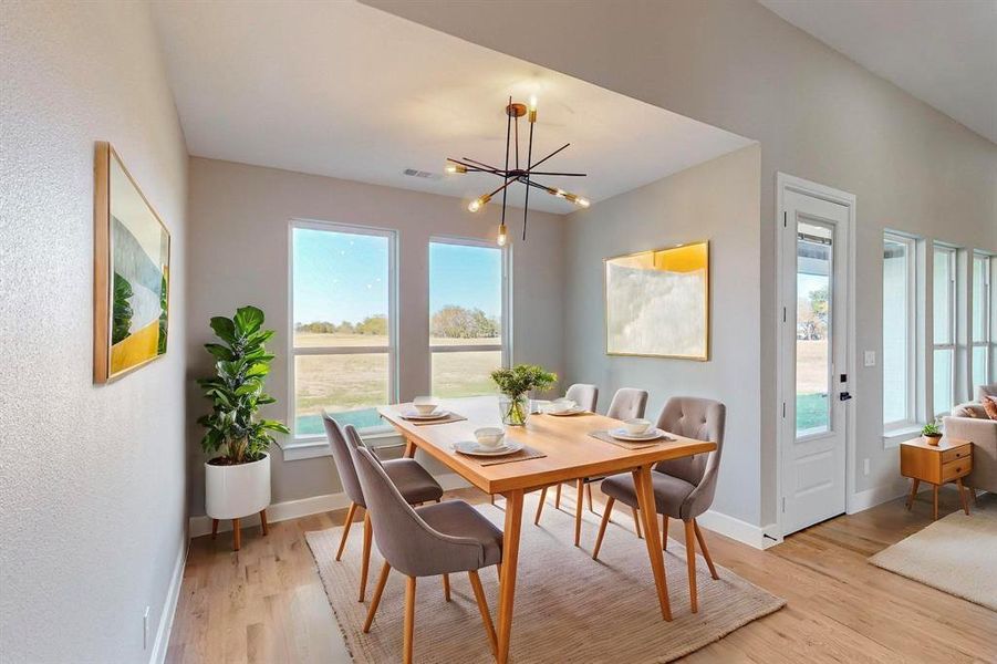 Dining area with an inviting chandelier and light wood-type flooring