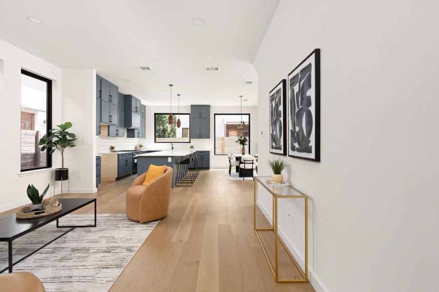 An airy interior showcases light wood flooring and a modern, open-concept design.
