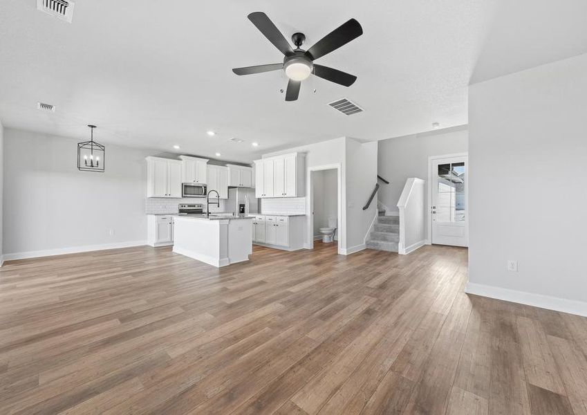 Another great view of the main living areas in this home, including a new peek of the half bath