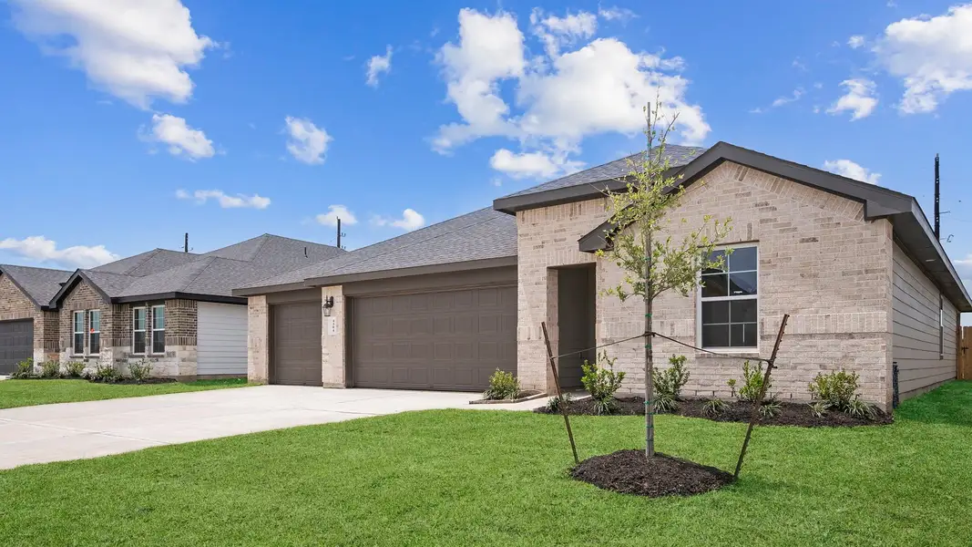 Front exterior of a new home in Tamarron, Fulshear, TX, highlighting curb appeal (Image 2).