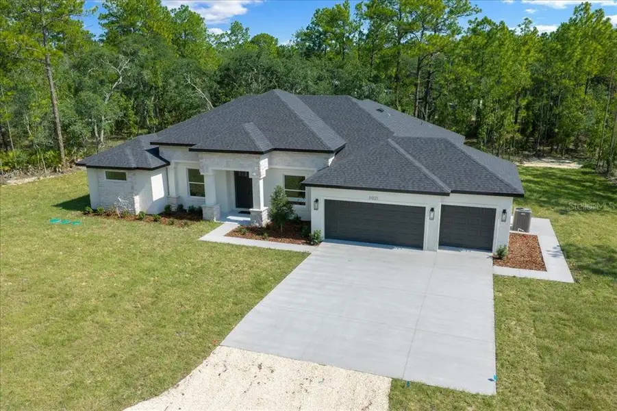 Front exterior of a new home in , Weeki Wachee, FL, highlighting curb appeal (Image 32). Front exterior of a new home in , Weeki Wachee, FL, highlighting curb appeal (Image 32).
