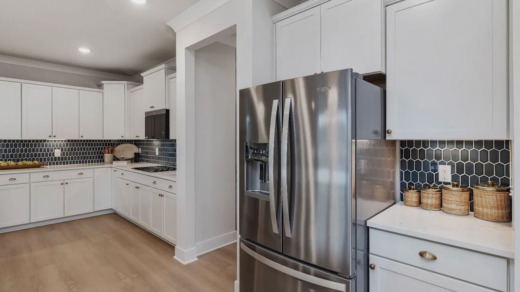Stonefield home plan open concept kitchen with massive island and abundant cabinetry overlooking the family room/breakfast Stonefield home plan open concept kitchen with massive island and abundant cabinetry overlooking the family room/breakfast