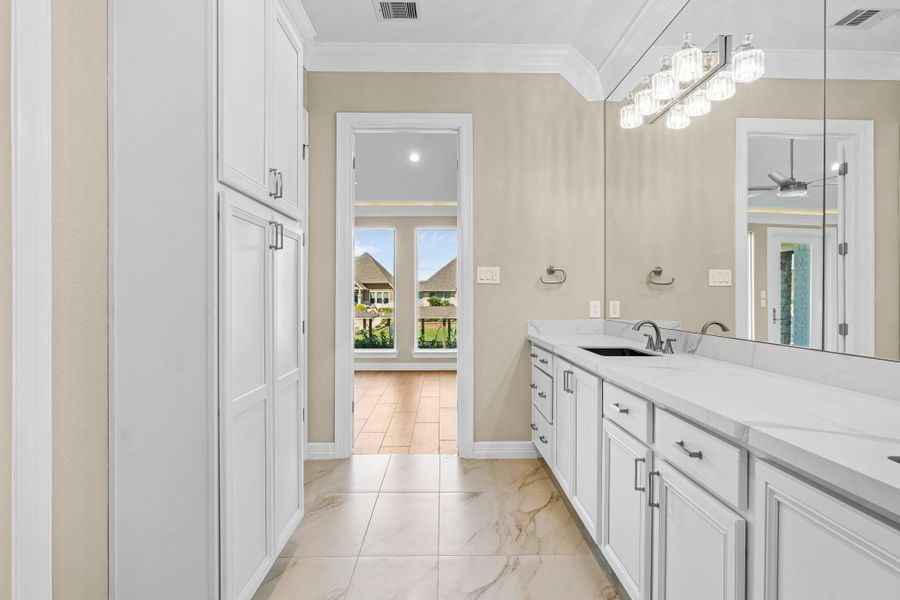 Alternate angle of the primary bath showcasing the elegant dual vanities, quartz counters, and beautiful natural light.