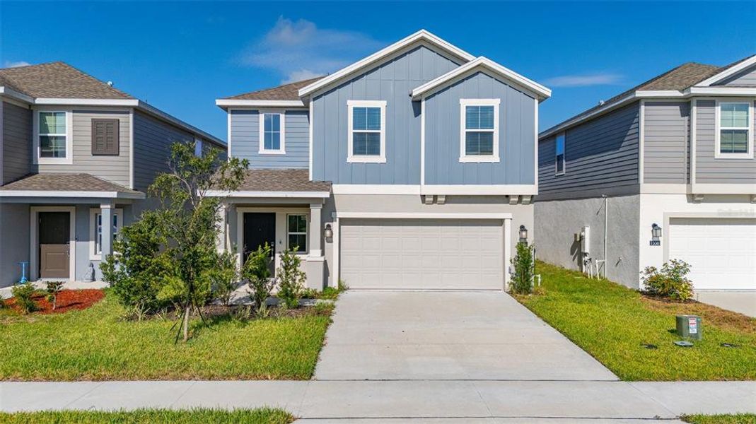Front exterior of a new home in Peace Creek Reserve, Winter Haven, FL, highlighting curb appeal (Image 30).