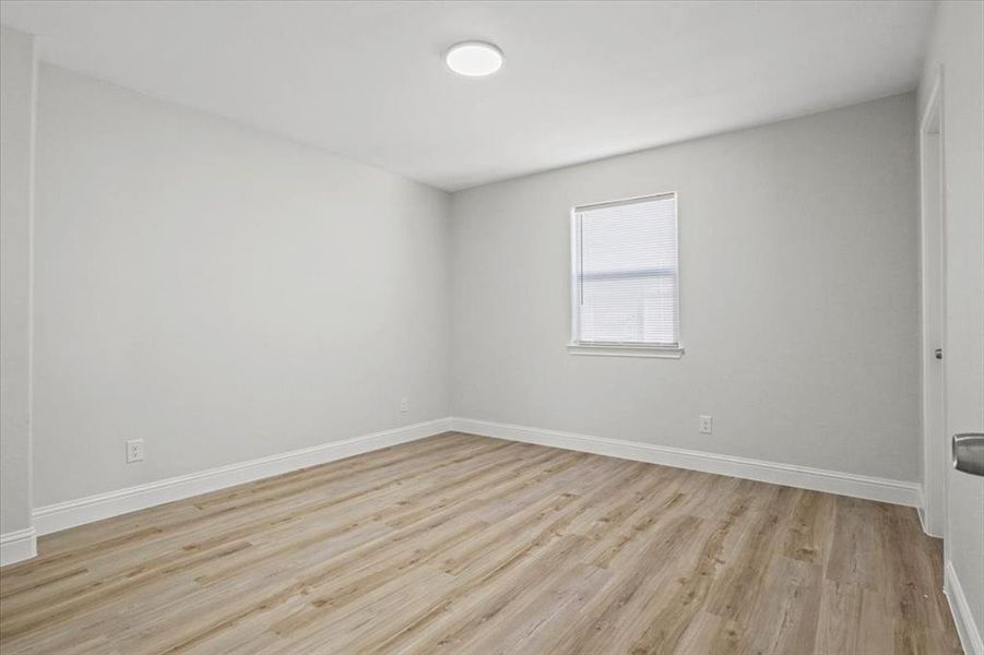 Unfurnished room with light wood-type flooring